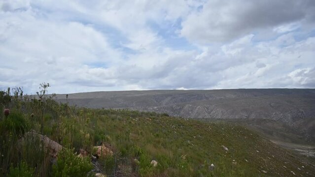 a hyperlaps of clouds moving over the cloetesberg mountain range in the little karoo semi desert area of the western cape province of south africa 