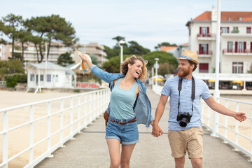 Fototapeta na wymiar romantic couple walking on the pier