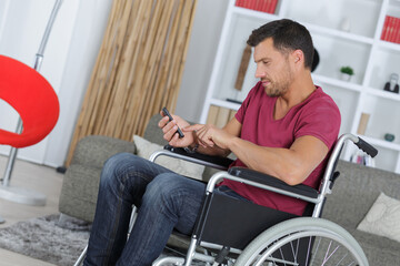 man on the wheelchair sending text messages