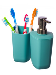 Turquoise glass with blue, red, green and orange toothbrushes complete with soap dispenser on a white background. The vertical position of the frame. Highlighted in white. 