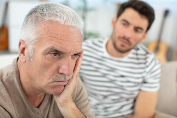 offended senior male ignoring middle-aged son