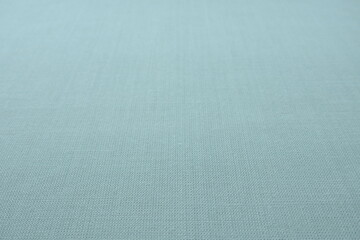 blue gray background fabric texture. A piece of woolen cloth is neatly laid out on the surface....