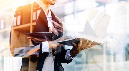 Businessman and team analyzing financial statement Finance task. with smart phone and laptop and...