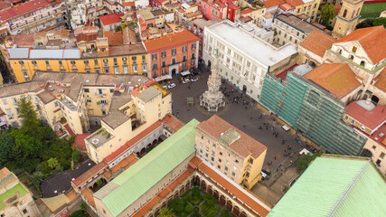 Aerial view of the square of Gesù Nuovo in Naples, Italy. At center of the square is the Spire of the Immaculate Virgin. The monument overlooks Via Spaccanapoli.