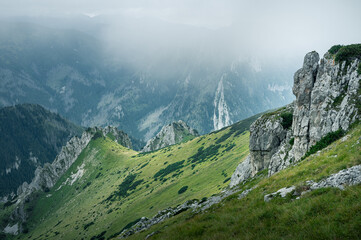 Breathtaking views over the valley of impressive Tatra mountains in misty weather. National park in Zakopane, Poland.