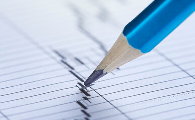 Checking the value of securities. Pencil, share listing and checking financial chart. Concept of banking, financial report and financial audit.