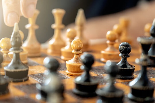 pawn with other figures on the vintage old chess board