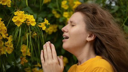 Portrait of beautiful young allergic woman is suffering from pollen allergy or cold on natural...