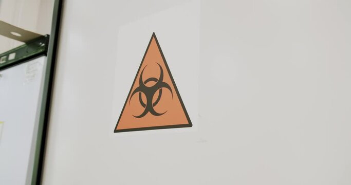 The radioactive sign in the laboratory. Biohazard sign on laboratory wall. Caution sign for authorised personnel. Warning symbol of chemical contamination, toxic materials.