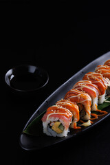 Salmon Sushi roll Japanese food isolated in black background