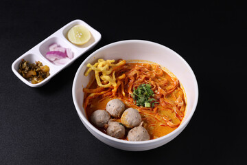 Khao Soi Thai Curry soup isolated in black background