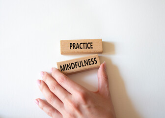 Practice Mindfulness symbol. Concept words Practice Mindfulness on wooden blocks. Businessman hand. Beautiful white background. Medical and Psychology and Practice Mindfulness concept. Copy space.