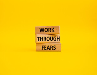 Work through fears symbol. Wooden blocks with words Work through fears. Beautiful yellow background. Business and Work through fears concept. Copy space.