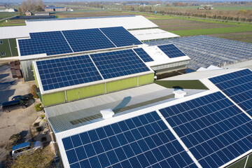 Flower bulb company with solar panels in a row on a roof. Photo taken with a drone.
Photovoltaic...