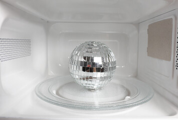 Disco ball inside a microwave oven close-up
