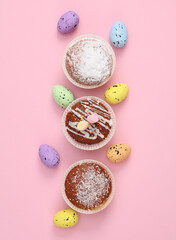 Fototapeta na wymiar Happy Easter. Cupcakes with Easter eggs on pink background. Top view