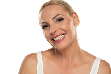 Portrait of senior middle aged happy blond woman with makeup  on white background