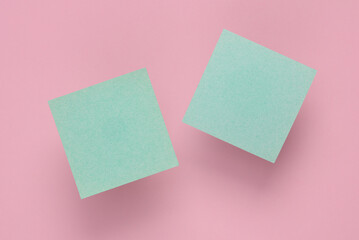 Empty Memo square sheets of paper on pink background