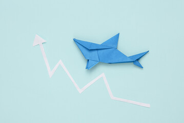 Fototapeta premium Origami shark with growth arrow on blue background