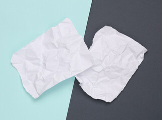 White crumpled piece of papers on paper background