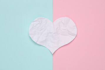 Crumpled paper heart on pink blue background. Love concert