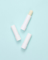 Lip balms on a blue background. Personal hygiene