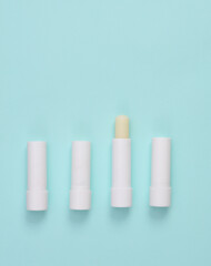 Lip balms on a blue background. Personal hygiene