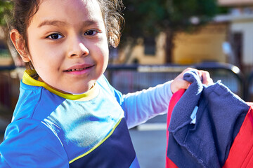 latin girl football player in a sport suit with getting ready for a elementary children soccer match