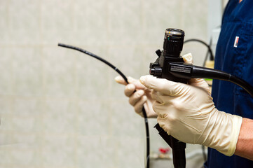 Endoscope in the hands of doctor. Medical instruments used in gastroscopy.Gastric probe