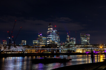 Fototapeta na wymiar Beautiful view of the city of London by night, glittering skyscrapers across the river Thames