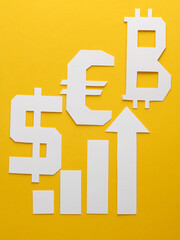 Paper-cut columns of a chart tending upwards and different currencies symbols on yellow background. Analytics, business concept