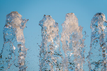 Splashes of water against the blue sky background