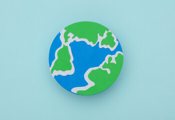 Handmade, children's art. Planet earth on a blue background.