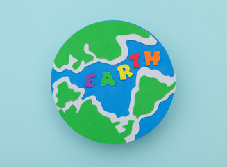 Planet earth with word earth on blue background.