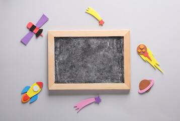 Chalk board in handmade space astronomical attributes on a gray background. Education concept