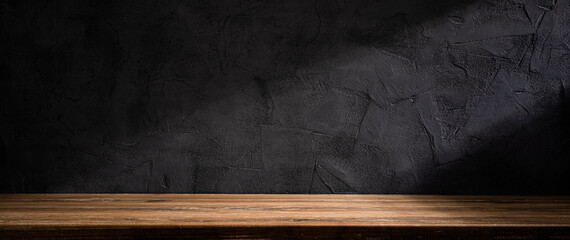 Wooden table or counter top with black stone wall background