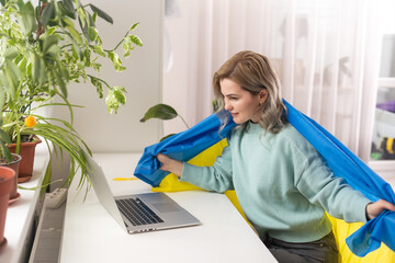 woman with flag of Ukraine and laptop