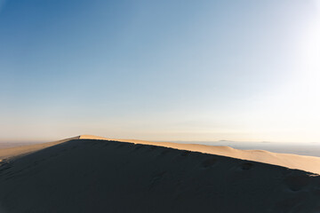 Fototapeta na wymiar one sand dune at early morning in the middle eastern desert, Qatar, 