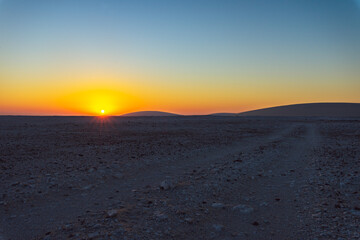 Fototapeta na wymiar sand dune in the desert and early morning sun