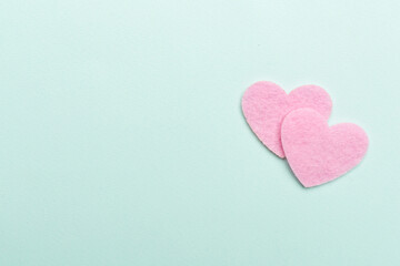 Felt hearts on color background, top view