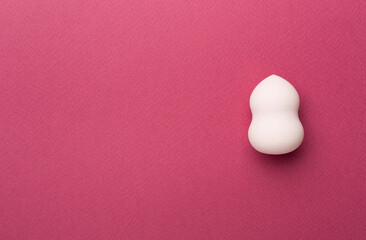 Beauty blender on color background, top view