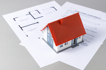 Model house, contract documents and plan. Purchase and sale agreement concept.