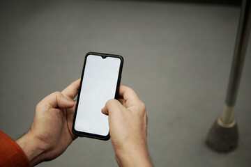 man's hands taking cell phone in the subway