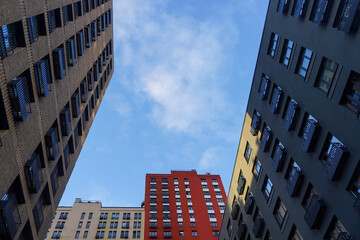 Colorful modern high-rise buildings against blue sky, up view