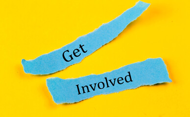 GET INVOLVED text on a blue pieces of paper on yellow background, business concept