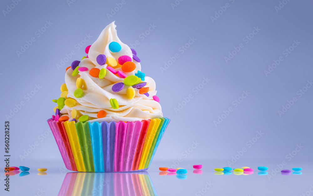 Wall mural cupcake. happy birthday. tasty birthday cupcake with white cream icing and rainbow sprinkles. sweet 