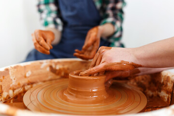 Cropped Image of Unrecognizable Females Ceramics Makers working with Pottery Wheel in Cozy Workshop Makes a Future Vase or Mug, Creative People Handcraft Pottery Class