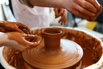 Cropped Image of Unrecognizable Female Ceramics Maker working with Pottery Wheel in Cozy Workshop Makes a Future Vase or Mug, Creative People Handcraft Pottery Class
