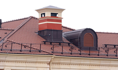 house with a roof from a burgundy shingles with a pipe  and attic window