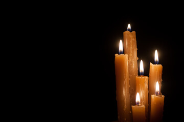 Six burning candles against a black background. International Holocaust Remembrance Day, January 27.